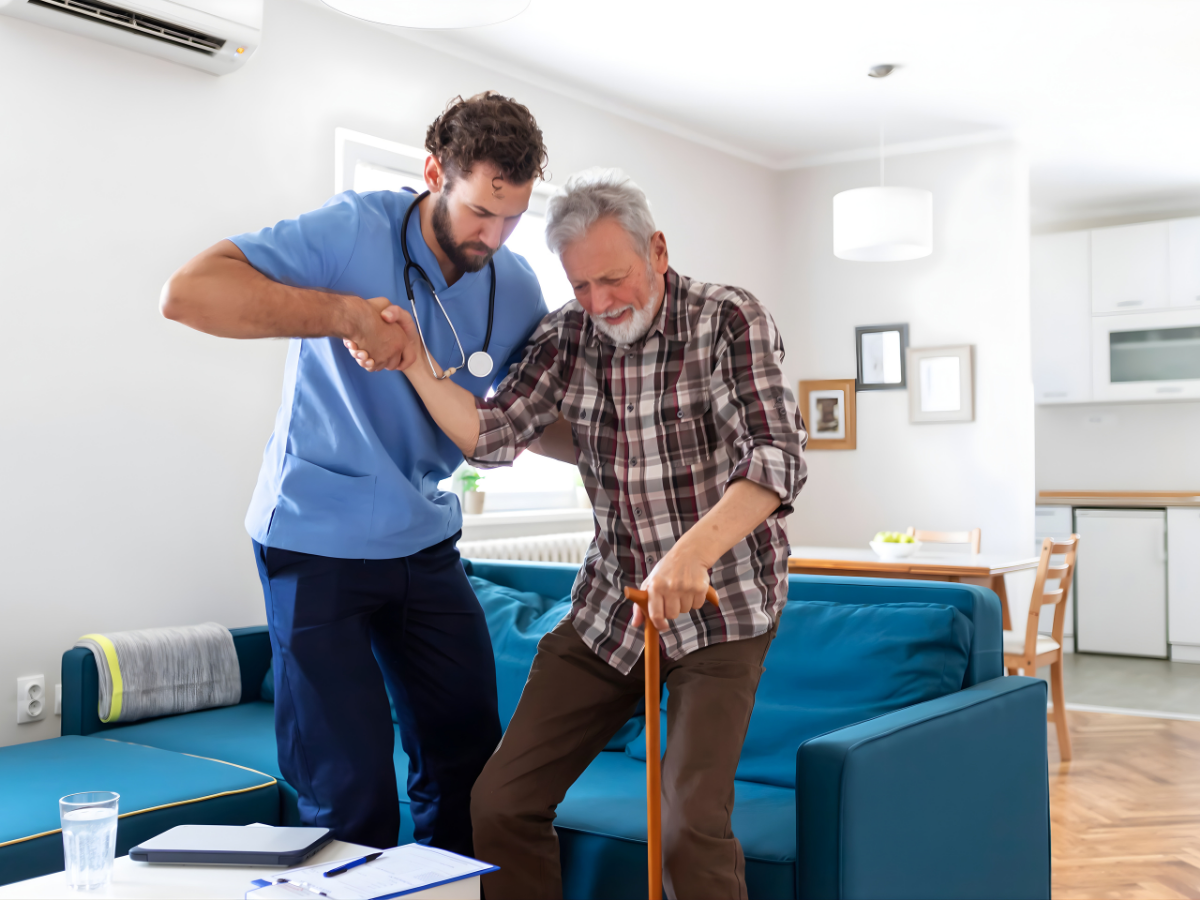 Compassionate caregiver providing palliative home support to a senior in a comfortable home environment